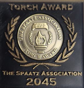 The bronze Torch Award coin, engraved with a Spaatz number.